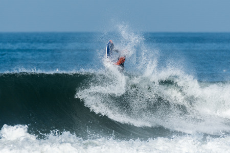 Bodyboarder in action on the ocean waves on a sunny day.の写真素材