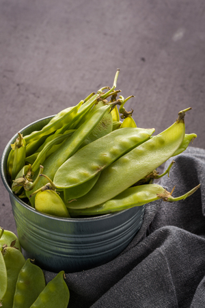 Organic Green Sugar Snap Peas Ready to Eat on cement background.の写真素材