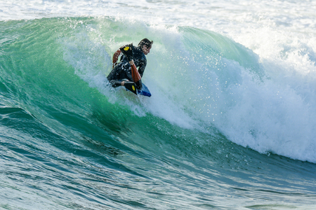 Bodyboarder in action on the ocean waves on a sunny day.の写真素材