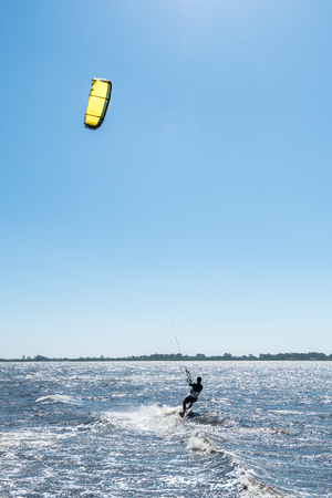 Kiteboarder enjoy surfing on a sunny day.の写真素材