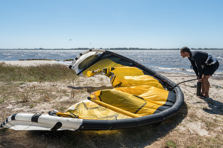 Kiteboarder preparations for surfing on a sunny day.の写真素材