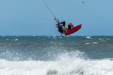 Kiteboarder enjoy surfing on a sunny day.