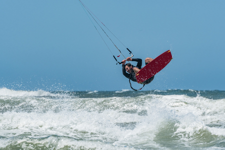 Kiteboarder enjoy surfing on a sunny day.の写真素材