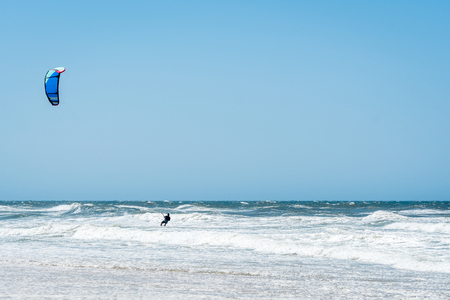 Kiteboarder enjoy surfing on a sunny day.の写真素材
