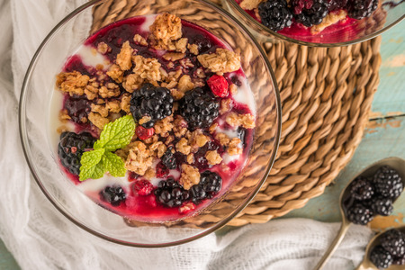 Yogurt desert with raspberries, blackberry and mint.の写真素材