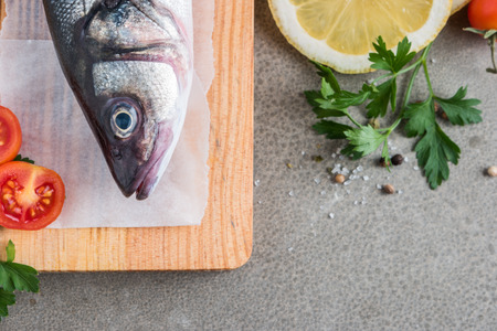 Fresh fish sea bass on wooden table.の写真素材