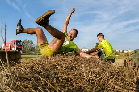 ESTARREJA, PORTUGAL - SEPTEMBER 23: Athletes overcoming the hay osbtacle at the Biorace on september 23, 2017 in Estarreja, Portugal.のeditorial素材