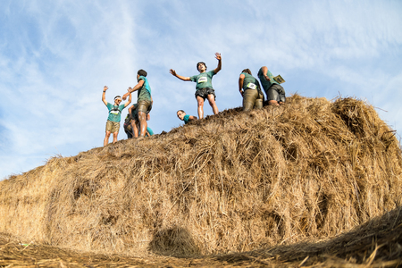 ESTARREJA, PORTUGAL - SEPTEMBER 23: Athletes overcoming the hay osbtacle at the Biorace on september 23, 2017 in Estarreja, Portugal.のeditorial素材