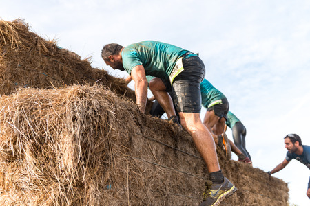 ESTARREJA, PORTUGAL - SEPTEMBER 23: Athletes overcoming the hay osbtacle at the Biorace on september 23, 2017 in Estarreja, Portugal.のeditorial素材