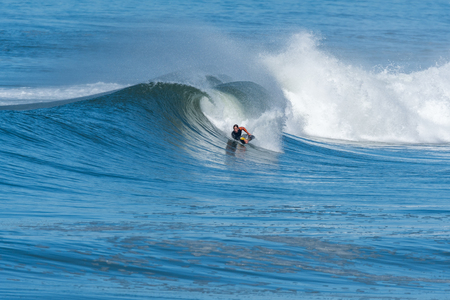 Bodyboarder in action on the ocean waves on a sunny day.の写真素材