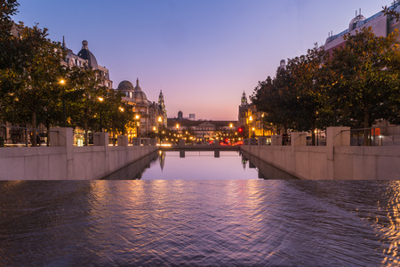 Sunset at an artificial reservoir on the Avenue of the Allies (Avenida dos Aliados) in Porto, Portugal. Porto is one of the most popular tourist destinations in Europe.の写真素材