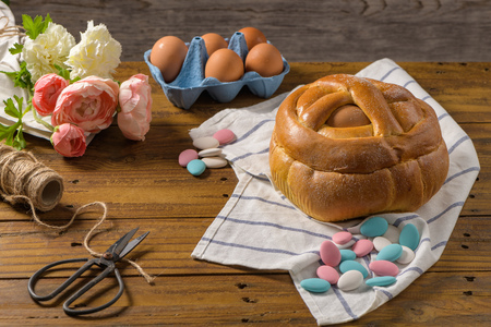 Easter folar with egg on wooden table top.