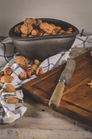 Walnuts, hazelnuts, peanuts and nuts on wooden table.の写真素材