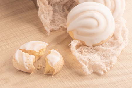 Coockies with egg white cover. Portuguese sweets known as cavacas on napkin in a table.の写真素材