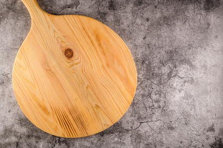 Top view of wooden cutting board on old concrete countertop.の写真素材