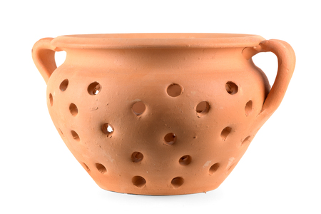 Traditional portuguese ceramic pot with holes for baking chestnuts isolated on white backgroundの写真素材