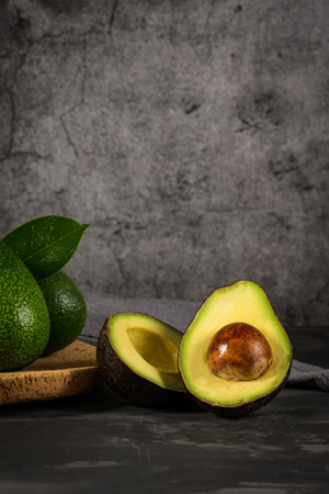 Delicious avocados in a cork plate on kitchen countertop.の写真素材