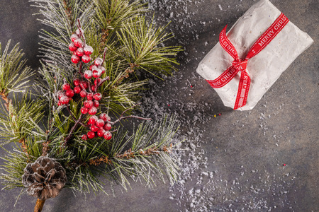Christmas background with Christmas gift, pine cones, red striped canes on background with Fir branches. Xmas and Happy New Year composition. Flat lay, top viewの写真素材