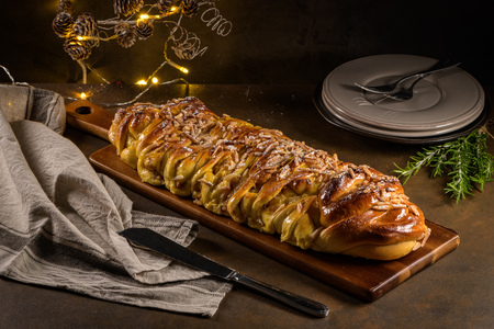 Christmas braided cinnamon cake on festive table.