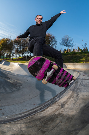 Skateboarder on a grind at sunset at the local skatepark.の写真素材