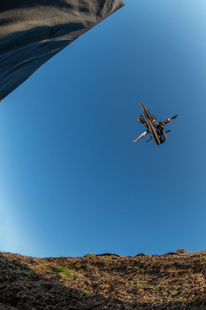 BMX Bike jump over a dirt trail on a dirt track.の写真素材