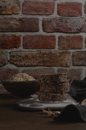 Raw veggie burger with black beans with on wood countertop.の写真素材