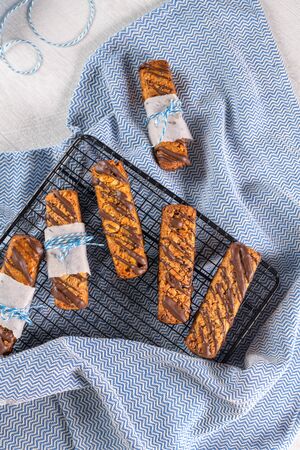 Cereal bars with peanuts and chocolate on kitchen counter top.の写真素材