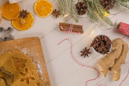 Raw dough for christmas cookies and cookie cutters on kitchen countertop.