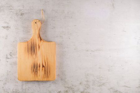 Top view of wooden cutting board on old stone countertop.の写真素材