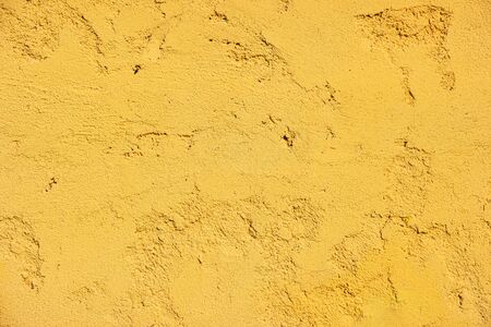 Yellow texture of a colorful painted wallの写真素材