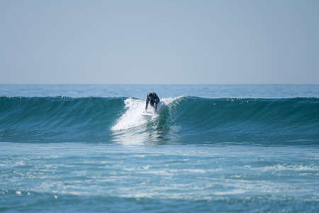 Soul surfer girl riding a wave in Furadouro beach, Ovar - Portugal.の写真素材