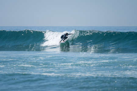 Soul surfer girl riding a wave in Furadouro beach, Ovar - Portugal.