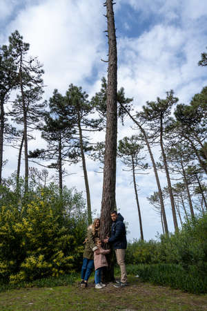 OVAR, PORTUGAL - 30th of JANUARY 2022: People hugging trees during the protest against the cutting of trees in the forest perimeter of the dunes of ovar, Portugal.のeditorial素材