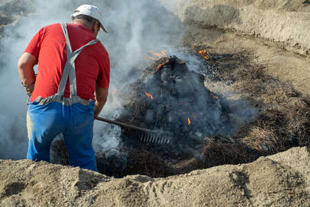 AMARANTE, PORTUGAL - APRIL 30: Final stage of uncovering the bonfire with the pieces of clay piled...