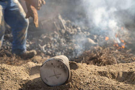 AMARANTE, PORTUGAL - APRIL 30: Final stage of uncovering the bonfire with the pieces of clay piled up during the cooking process of the black clay of Gondar on April 30, 2022 in Amarante, Portugal.のeditorial素材