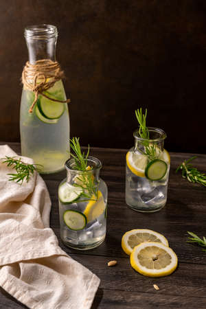 Water flavored with lemon, cucumber and rosemary leaves.の写真素材