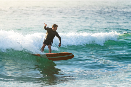 Surfer in action at sunset. Furadouro beach, Ovar - Portugal.の写真素材