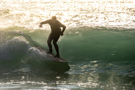 Surfer in action at sunset. Furadouro beach, Ovar - Portugal.