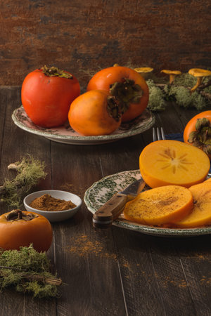 Delicious orange persimmons on wooden table.の写真素材
