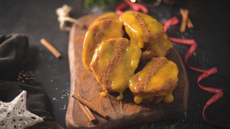 Traditional Christmas French Toast with egg yolk cream and cinnamon. Spanish Torrijas close up on...