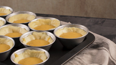 Egg tarts, traditional portuguese dessert, pastel de nata, custard tarts during home production on...