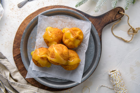Rabanadas poveiras with egg cream and cinnamon on a kitchen countertop during the Christmas season.