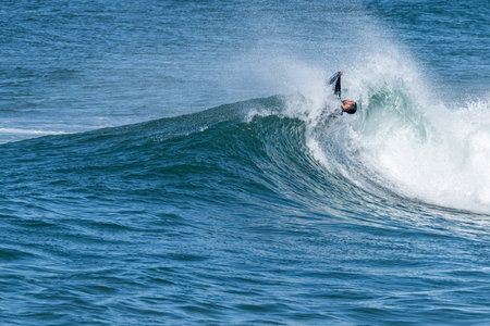 Bodyboarder surfing ocean wave on a sunny winter day.の写真素材