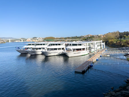 PORTO, PORTUGAL - CIRCA APRIL 2023: Douro cruises moored next to the Infante bridge.のeditorial素材