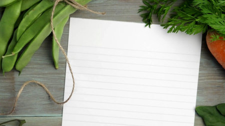 Blank white paper and fresh colorful vegetables on kitchen tableの写真素材