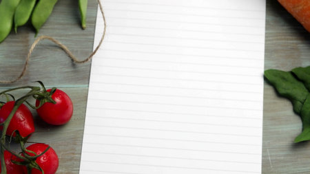 Blank white paper and fresh colorful vegetables on kitchen tableの写真素材