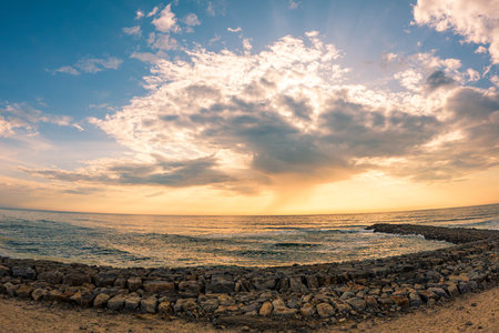 View of the seawall south of Furadouro beach in Ovar on a stormy day at sunset.の写真素材