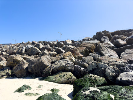 OVAR, PORTUGAL - AUGUST 5: The low tide reveals the damage caused by the force of the sea on the longitudinal wall of the Furdouro beach.のeditorial素材