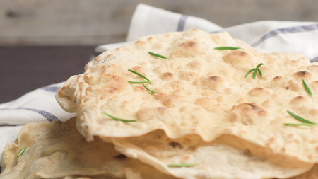 Homemade hot chapati on kitchen countertop background. Zooming slides.