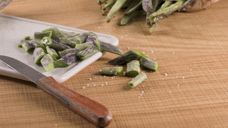 Heap of green beans on a rustic wooden table top view. Cutting board with green beansの写真素材